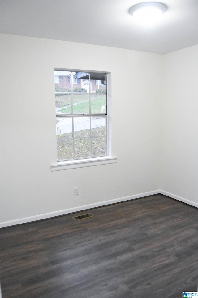 unfurnished room with dark hardwood / wood-style floors