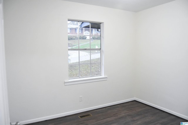 empty room with dark hardwood / wood-style flooring