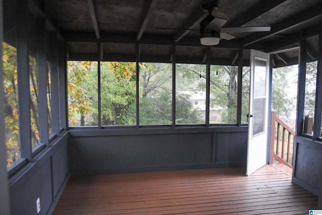 unfurnished sunroom with ceiling fan