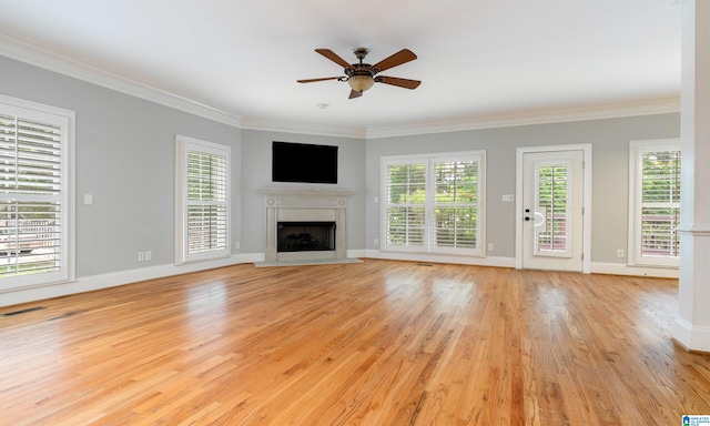 unfurnished living room with ceiling fan, light wood-type flooring, and ornamental molding