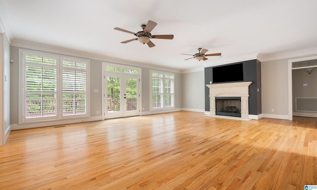 unfurnished living room with plenty of natural light, ceiling fan, light wood-type flooring, and crown molding