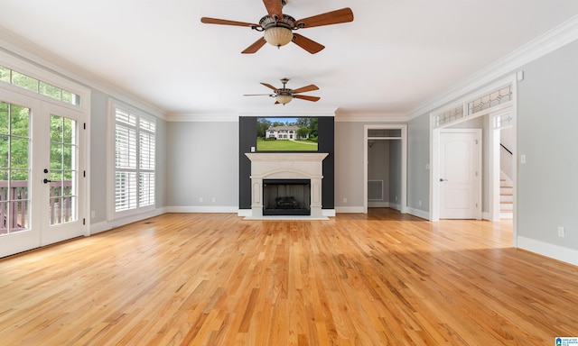 unfurnished living room with french doors, light hardwood / wood-style floors, and ornamental molding