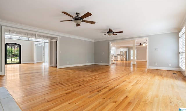 unfurnished living room featuring light wood-type flooring and crown molding