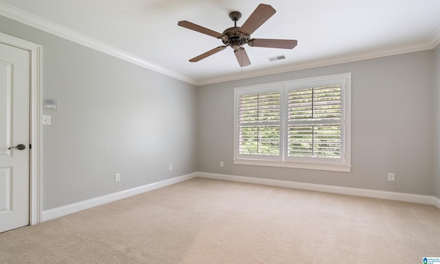 carpeted spare room featuring ceiling fan and crown molding