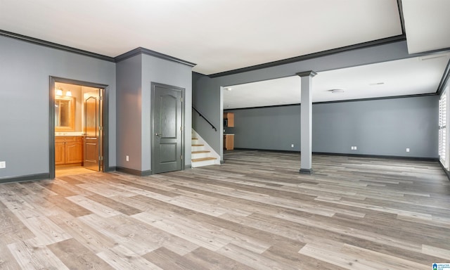 basement with crown molding and light wood-type flooring