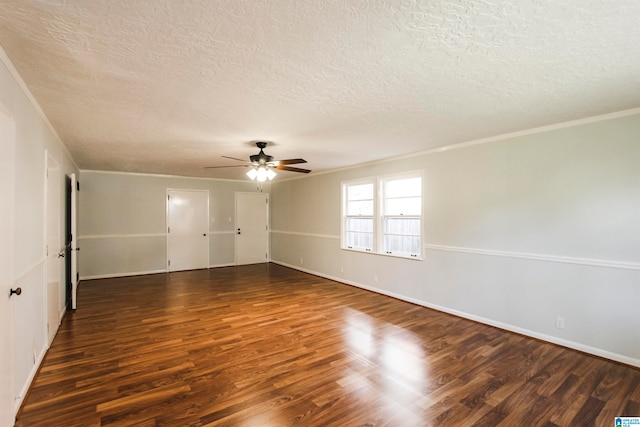 empty room with ceiling fan, dark wood-type flooring, a textured ceiling, and ornamental molding