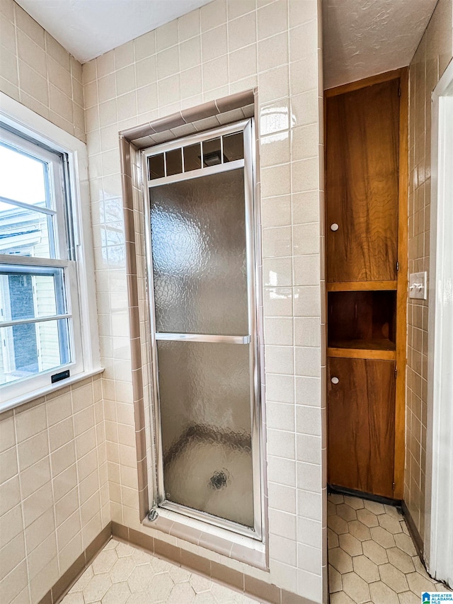 bathroom featuring tile patterned floors and tile walls