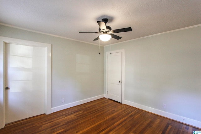 unfurnished room with ceiling fan, dark hardwood / wood-style flooring, a textured ceiling, and ornamental molding