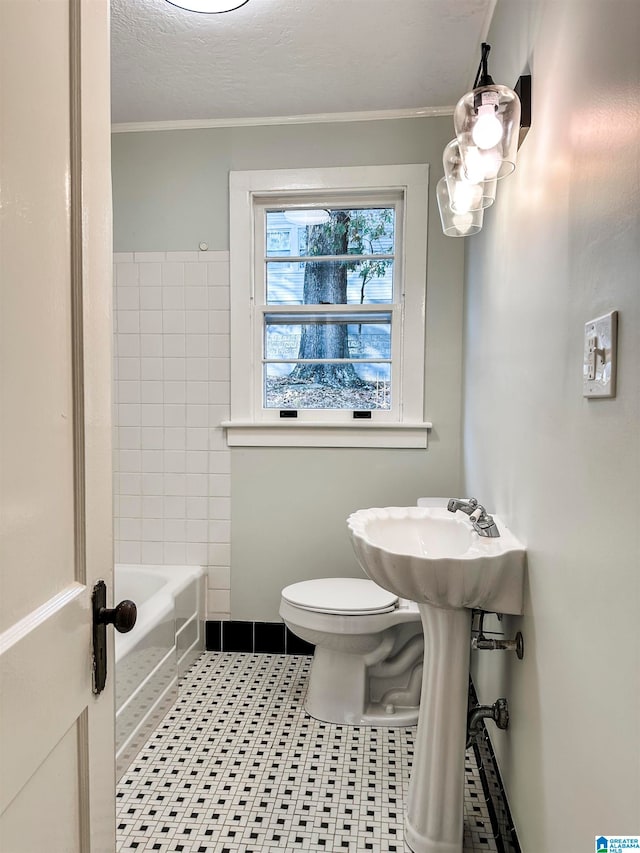 bathroom featuring tile patterned floors, a textured ceiling, toilet, and ornamental molding