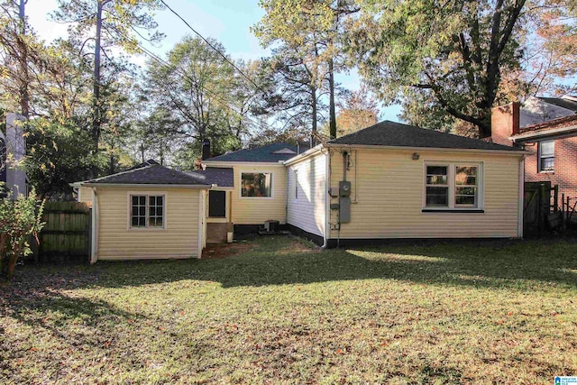 back of property with a yard and cooling unit