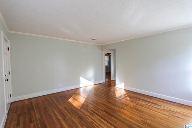 unfurnished room featuring hardwood / wood-style floors, a textured ceiling, and ornamental molding