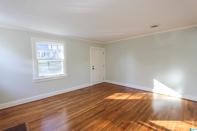 spare room with wood-type flooring and crown molding