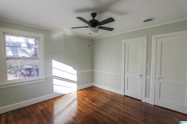 unfurnished room with ceiling fan, dark hardwood / wood-style flooring, and ornamental molding