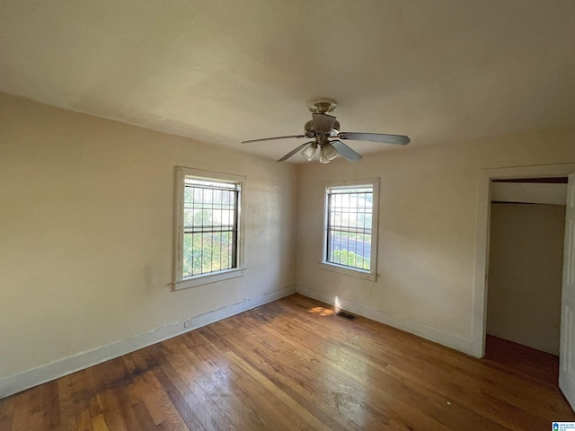 unfurnished bedroom featuring hardwood / wood-style flooring and ceiling fan