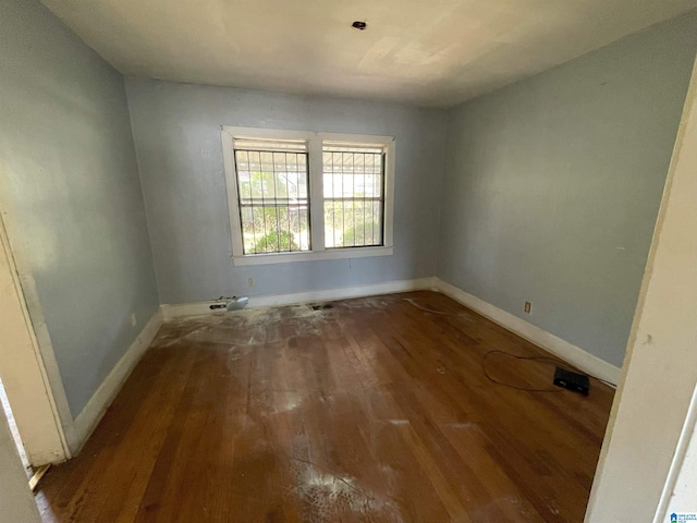 empty room with hardwood / wood-style floors