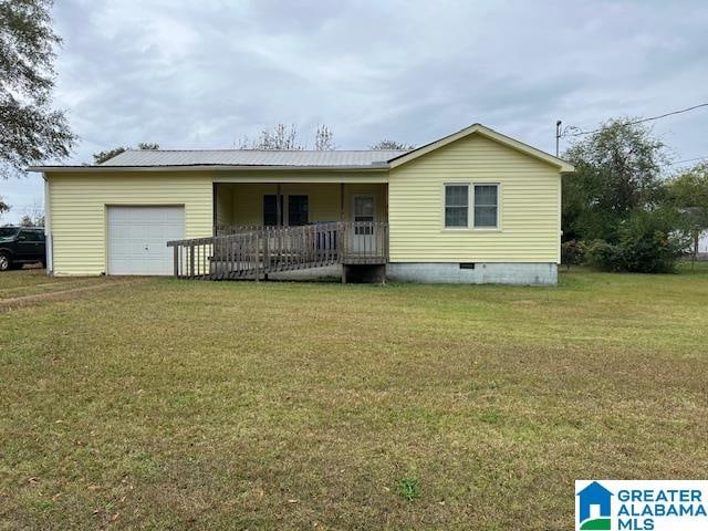 view of front of property with a garage, covered porch, and a front yard