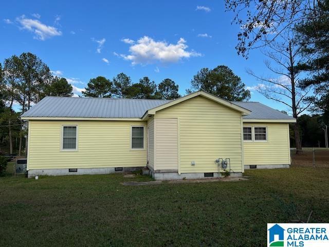 928 Horne Dr, Talladega, AL 35160 - back of house featuring crawl space, a yard, and metal roof