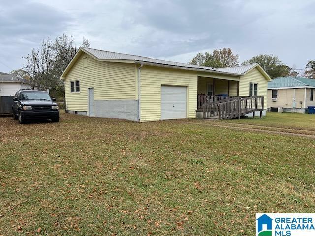 928 Horne Dr, Talladega, AL 35160 - view of home's exterior featuring an attached garage and a yard