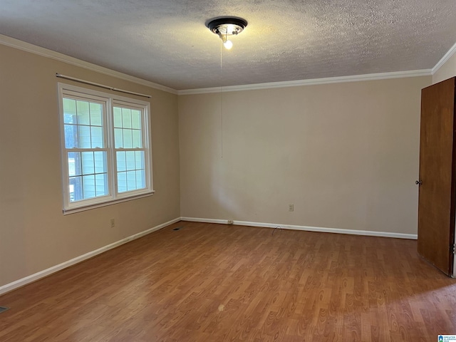 928 Horne Dr, Talladega, AL 35160 - empty room featuring wood finished floors, baseboards, crown molding, and a textured ceiling