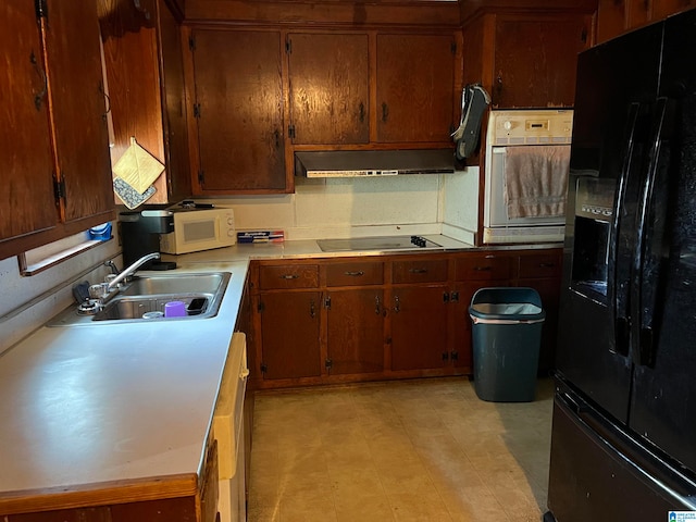 kitchen featuring sink and black appliances