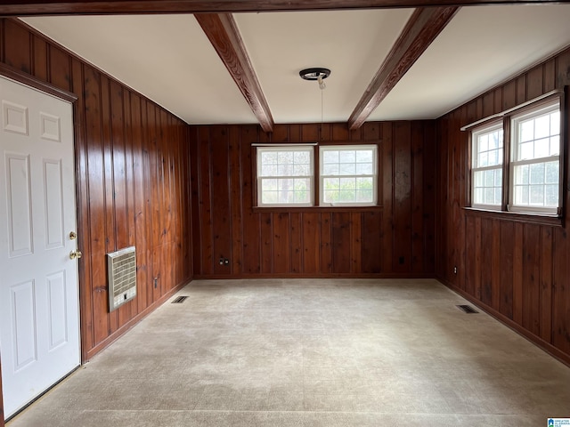 928 Horne Dr, Talladega, AL 35160 - spare room featuring beam ceiling, heating unit, wooden walls, light floors, and baseboards