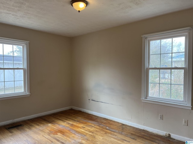 928 Horne Dr, Talladega, AL 35160 - empty room with healthy amount of natural light, wood finished floors, and baseboards