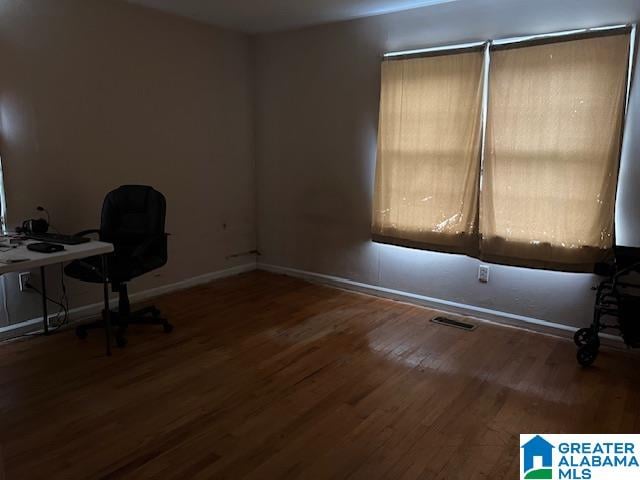 unfurnished office featuring hardwood / wood-style flooring