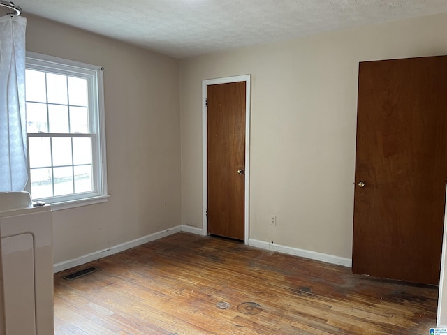 928 Horne Dr, Talladega, AL 35160 - spare room with hardwood / wood-style flooring, baseboards, and a textured ceiling