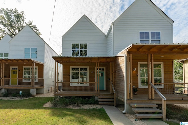 view of front of house featuring covered porch and a front yard