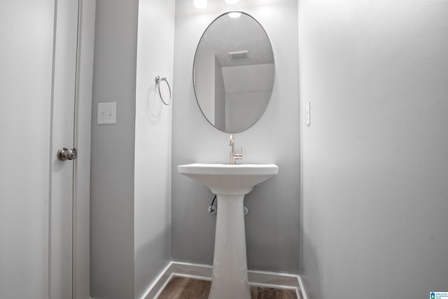 bathroom with wood-type flooring