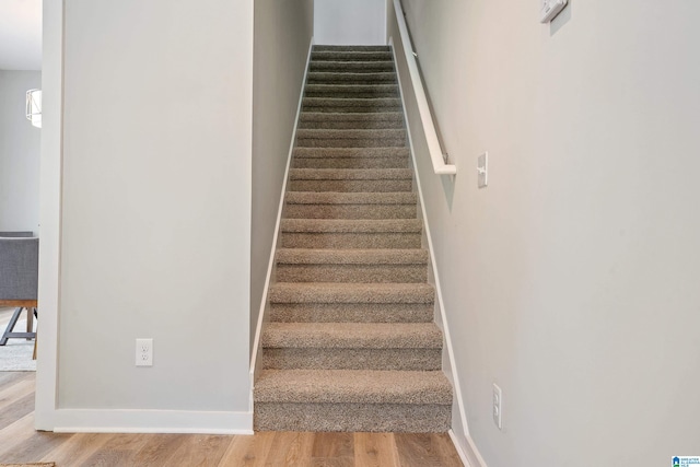 stairway featuring wood-type flooring