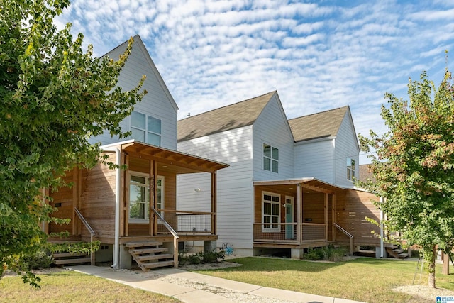 back of property with a porch and a yard