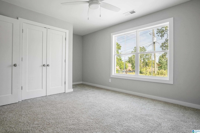 unfurnished bedroom with carpet floors, a closet, and ceiling fan