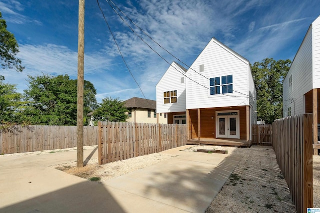 rear view of house featuring french doors