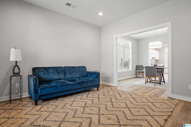 living area with hardwood / wood-style flooring