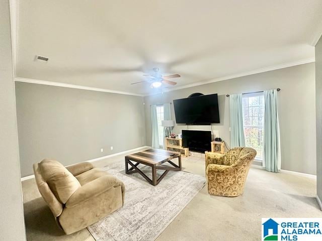 carpeted living room featuring ceiling fan and ornamental molding