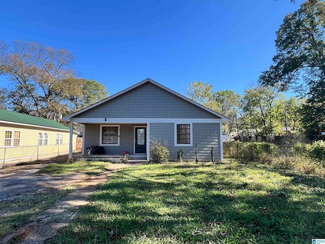 rear view of property with a porch and a yard