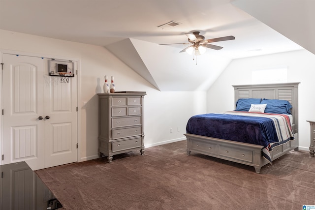 bedroom featuring vaulted ceiling, dark carpet, and ceiling fan