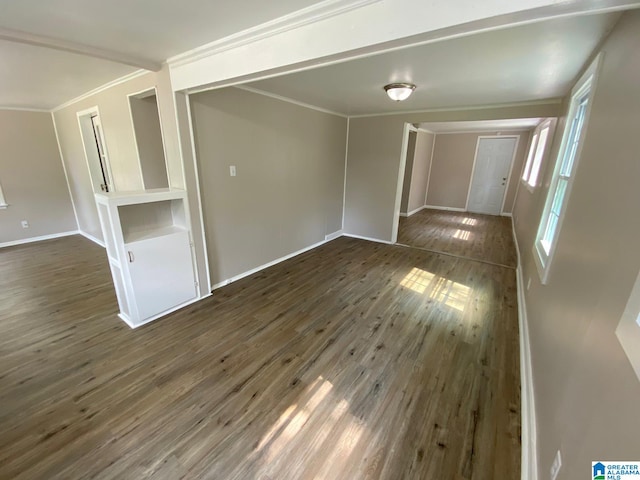 empty room featuring dark hardwood / wood-style flooring and ornamental molding