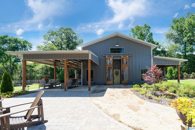 exterior space featuring an outdoor hangout area and a patio