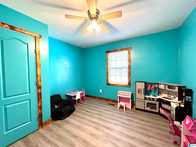 game room featuring light hardwood / wood-style flooring and ceiling fan