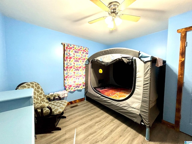 bedroom with ceiling fan and light hardwood / wood-style flooring