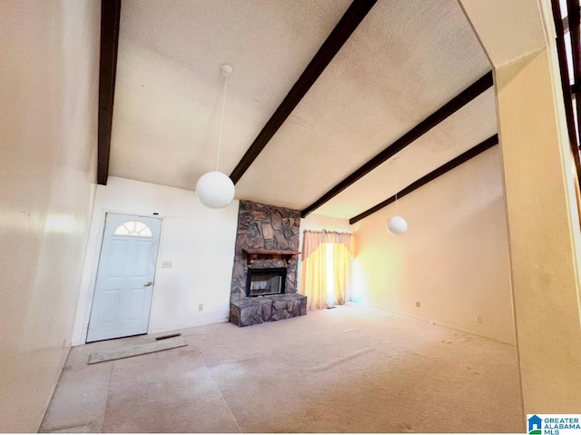 unfurnished living room featuring beam ceiling, carpet floors, a fireplace, and high vaulted ceiling