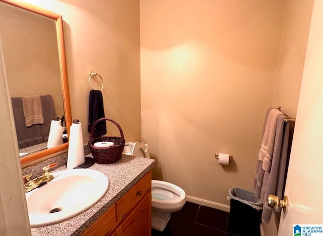 bathroom with tile patterned floors, vanity, and toilet