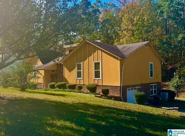 view of home's exterior with a yard and a garage