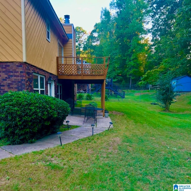 view of yard featuring a deck and a patio area