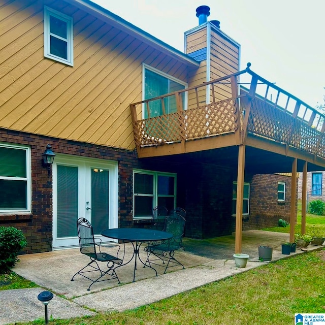 rear view of house featuring a patio and a deck