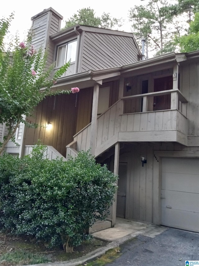 exterior space with a balcony and a garage