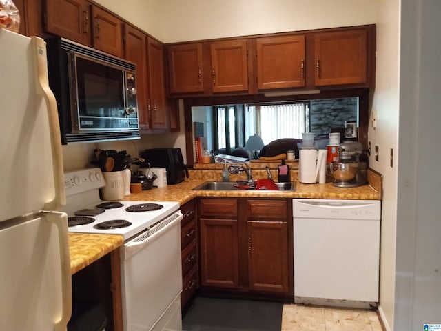 kitchen featuring white appliances and sink