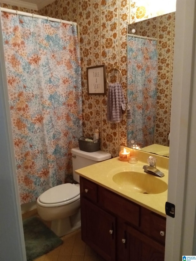 bathroom featuring tile patterned flooring, vanity, and toilet